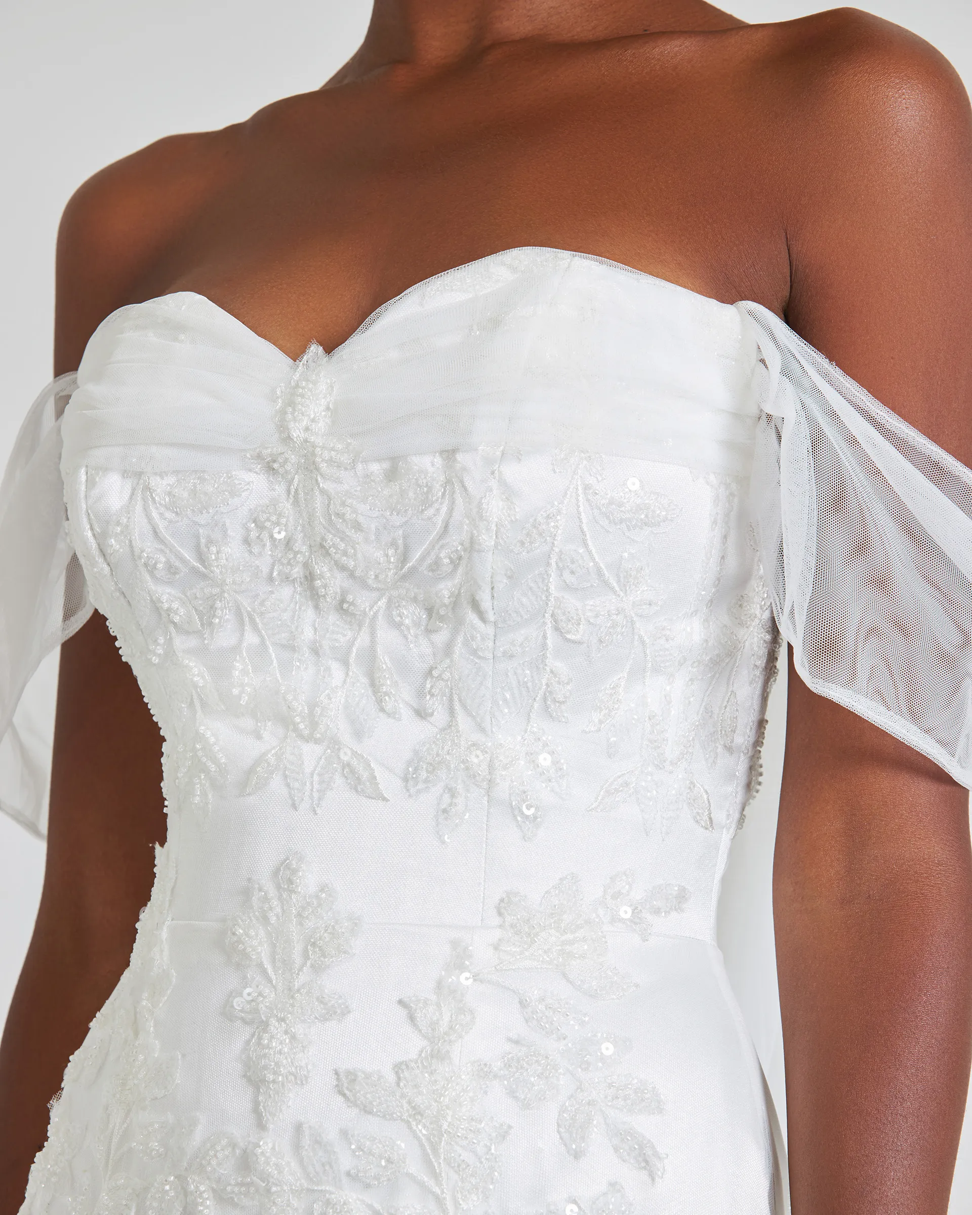 Ajoke, front detail: draped tulle along the sweetheart neckline, gathered at the centre front, over a corseted bodice of beaded lace appliqués.