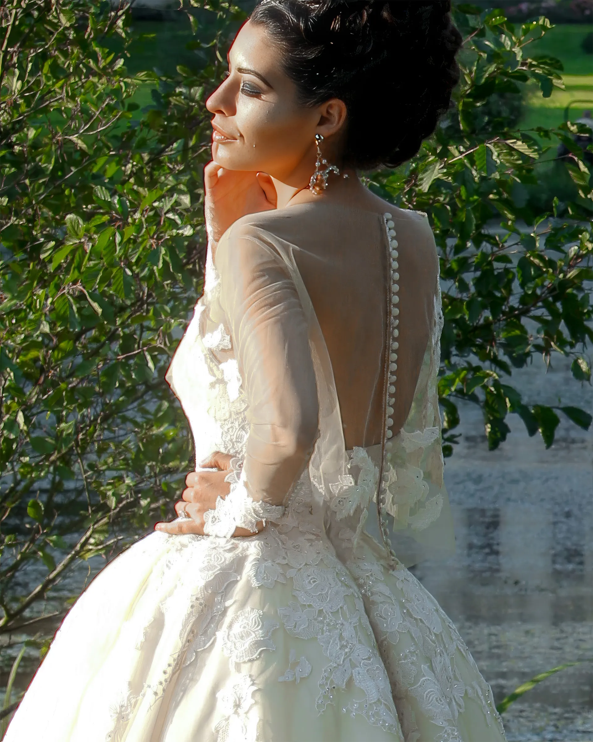 Clio, back detail: a line of covered buttons down the sheer tulle jacket, with guipure lace appliqués at the shoulders and over the skirt.