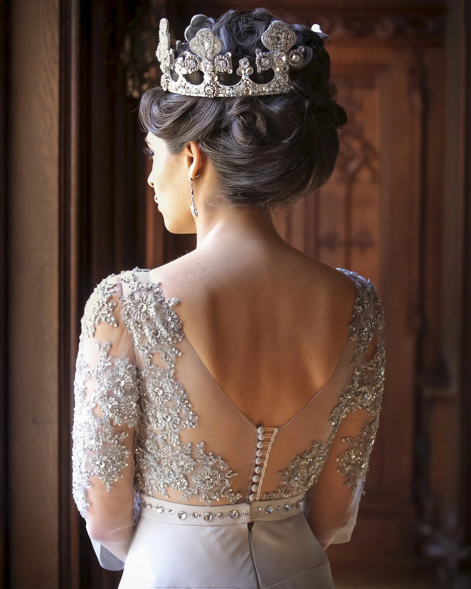 Erato, back detail beneath a jewelled crown: silver beaded lace on the illusion tulle, covered buttons down the spine and a crystal waistband.