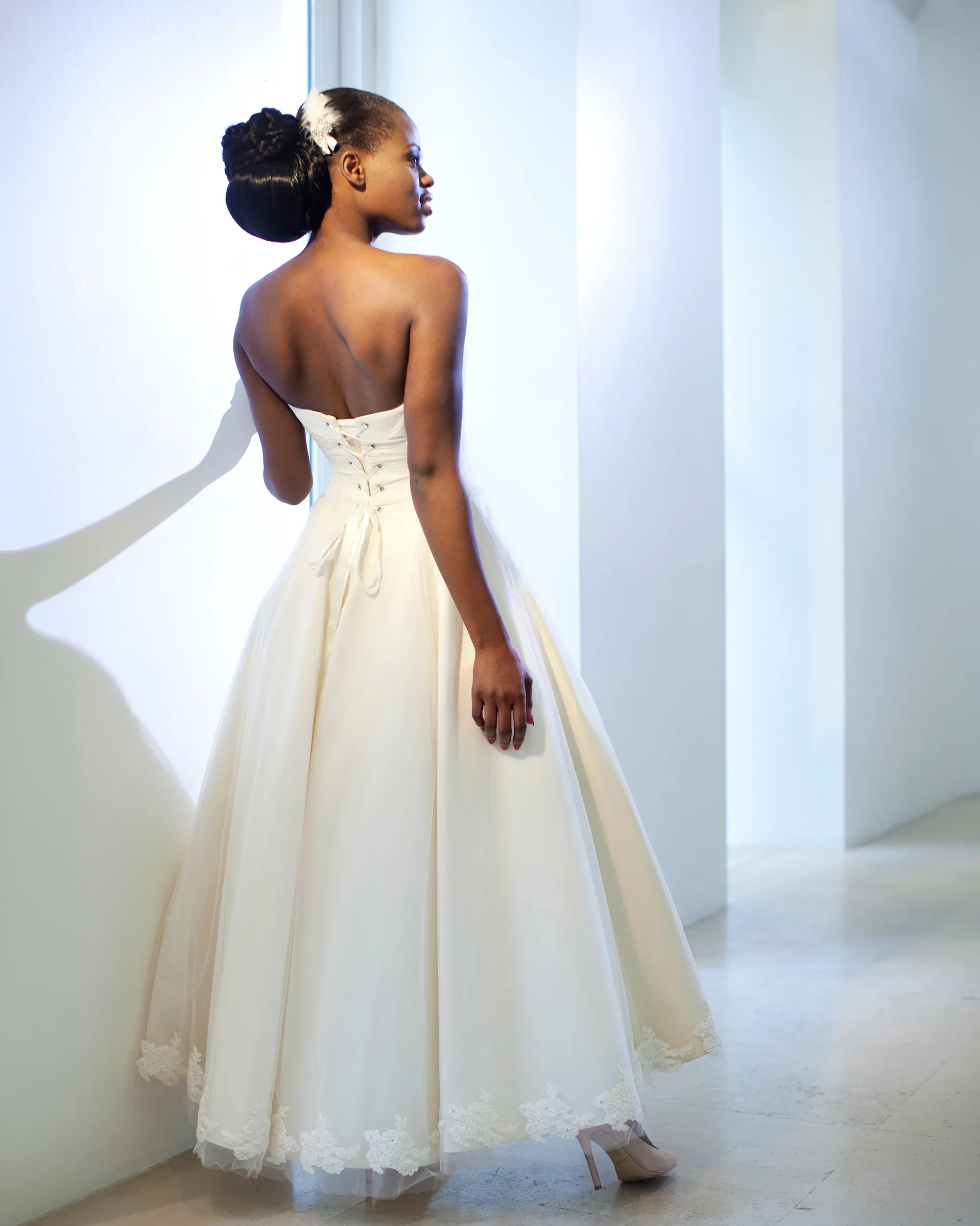 Giselle, back, without the chemise: a strapless laced back above the full ivory skirt with its lace-edged hem.