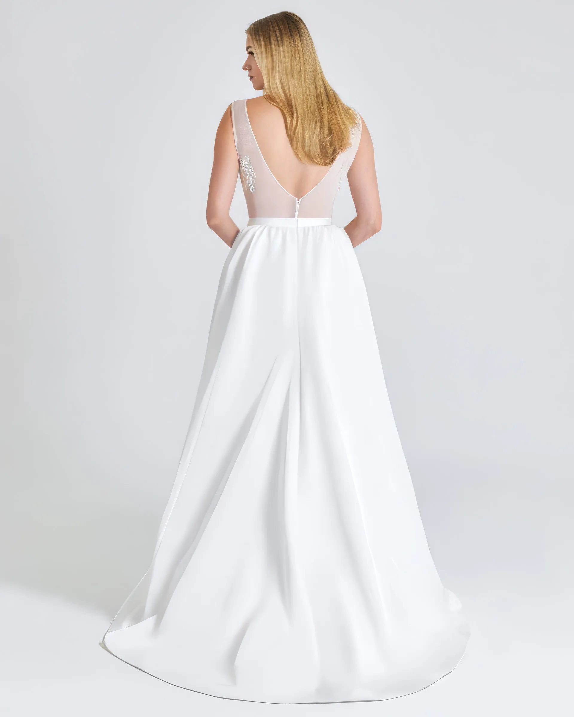 Ronke, back: a deep V of sheer tulle to the narrow waistband, and the full skirt falling into a gentle train.