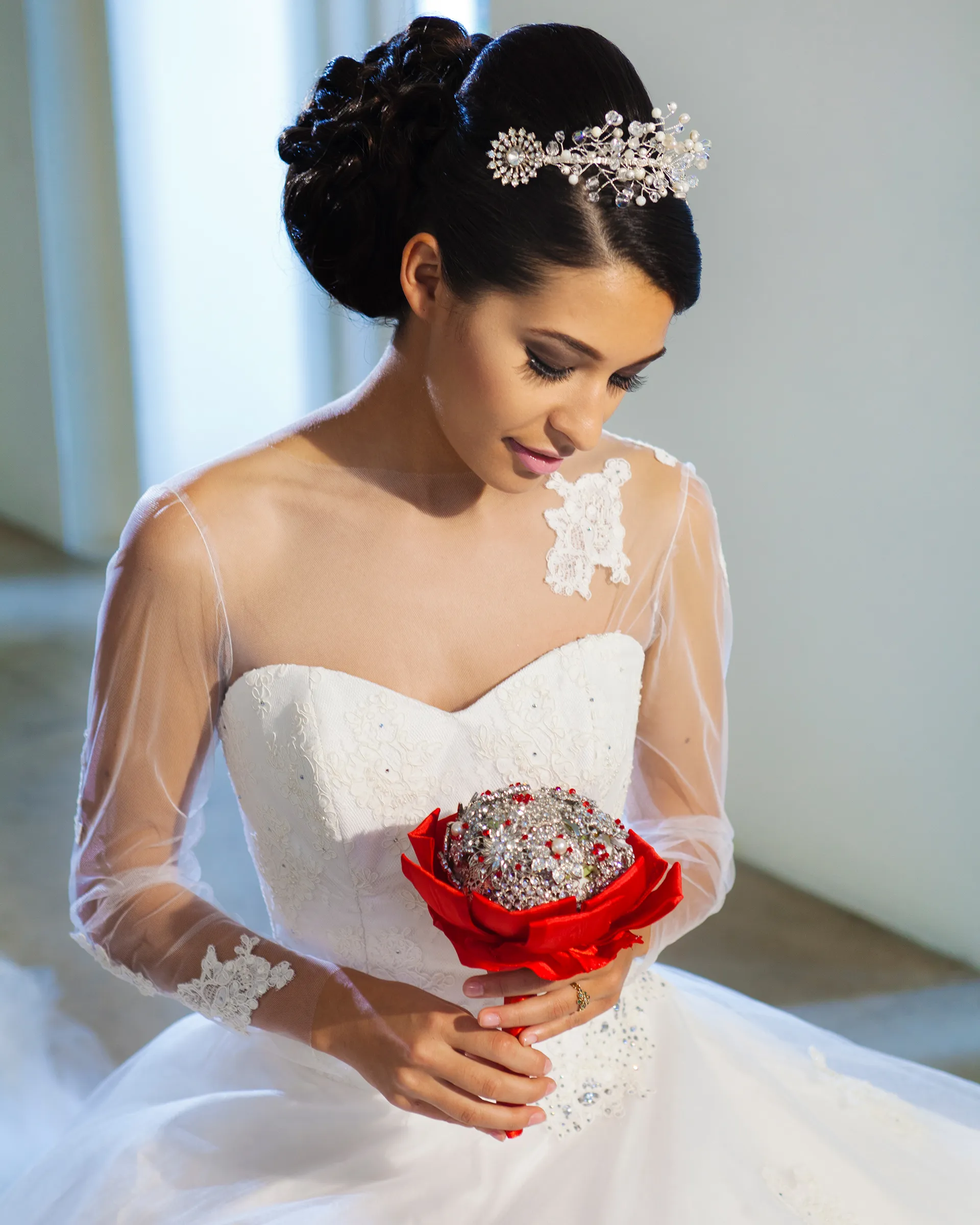 Titania, front detail, eyes lowered over a red brooch bouquet: the boat neck of the sheer chemise, a lace appliqué at the shoulder and the sweetheart bodice beneath.